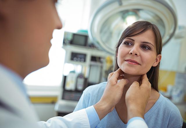 endocrine surgery - doctor examining woman's neck